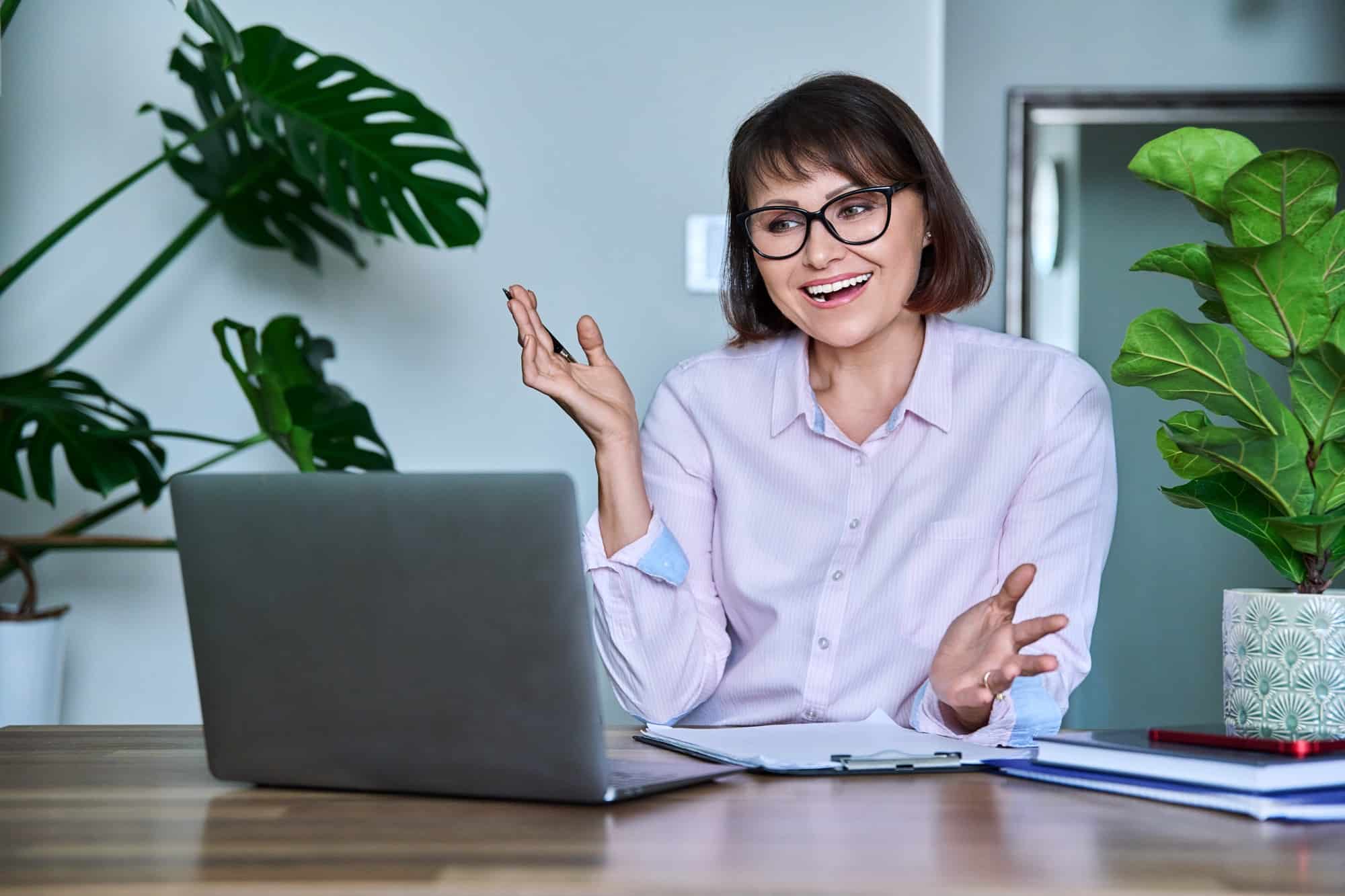mature woman using laptop for video call virtual meeting