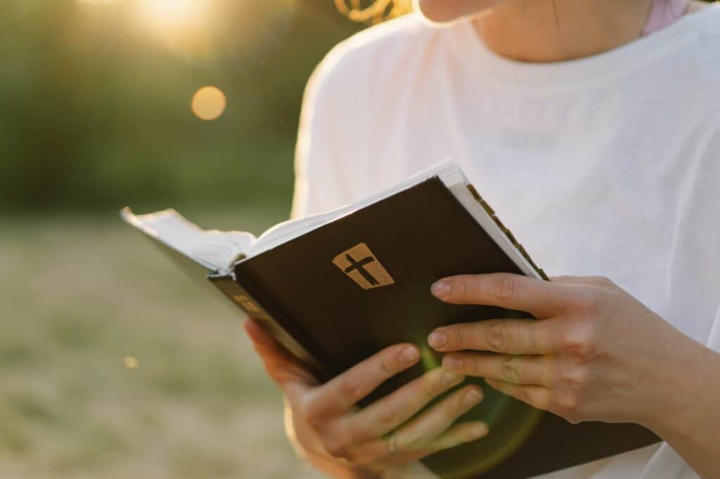 christian woman holds bible in her hands